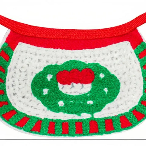 Crocheted dog muzzle with green and red design on a white background