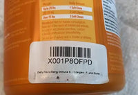 Close-up review photo from a customer showing the barcode label and dosage guidelines on the back of a Zesty Paws Aller-Immune Bites Peanut Butter jar.