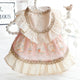 Delicate dress with lace collar and floral patterns on white background.