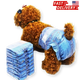 Dog wearing blue denim-style diapers with a stack of similar diapers.