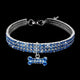 Dog collar with blue and silver crystal design and bone-shaped charm.