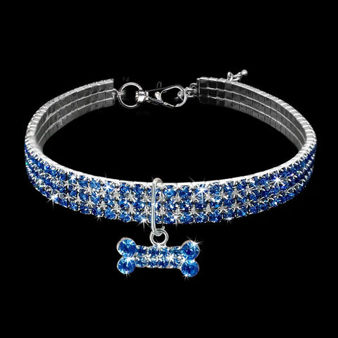 Dog collar with blue and silver crystal design and bone-shaped charm.