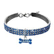 Dog collar with blue and silver crystals and bone charm on white.