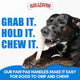 Black dog using easy-hold paw pad handles to grip and chew a Bullibone nylon toy.