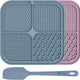 silicone dog lick mats in slate blue and dusty pink with a matching blue spatula.