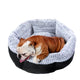 Dog lying in a gray and black pet bed.