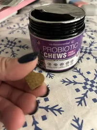 Customer review photo demonstrating the size of a single probiotic chew held in hand next to the opened product container.