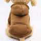 Dog wearing a brown fleece coat with a hood on white background.