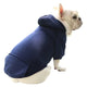 Dog wearing a navy blue hoodie on white background.