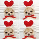 Dog wearing costume with red heart-shaped ears and bow tie.