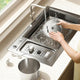 Person washing the stainless steel parts of the pet fountain in a kitchen sink to show easy cleaning.