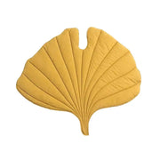 Extreme close-up of a yellow leaf-shaped pet bed, showing plush fabric texture and stitching