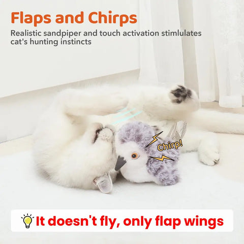 Playful cat lying on its back playing with an interactive flapping and chirping sandpiper bird toy
