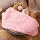 Fluffy pink blanket over cat bed with teddy bear design and cat.