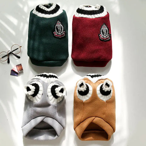 Four colorful dog sweaters with unique designs on light background.