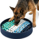 German Shepherd foraging for dry food inside a round navy blue snuffle mat with teal, white, and blue fabric loops.