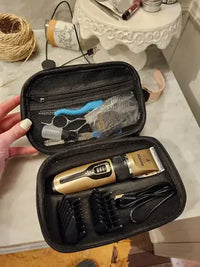 A customer holding an open black travel storage case containing a gold cordless pet grooming clipper, guide combs, and grooming scissors.