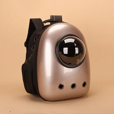 Gold pet backpack with a clear front on a beige background