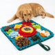 Golden Retriever lying next to a turquoise floral-style snuffle mat filled with hidden dog kibble.