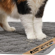 Close-up of cat paws stepping onto a grey Gorilla Grip cushioned litter trapping mat