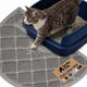 Grey half circle Gorilla Grip cat litter mat placed under a navy blue litter box