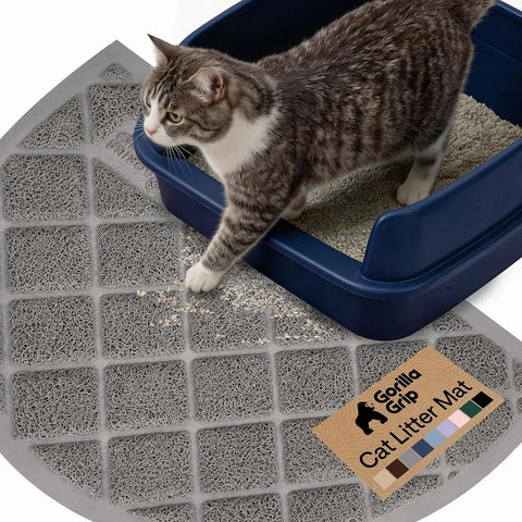 Grey half circle Gorilla Grip cat litter mat placed under a navy blue litter box
