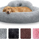 Golden retriever lying down in a large light gray plush calming donut dog bed