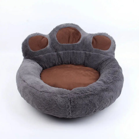 Gray paw-shaped pet bed with brown interior on white background.