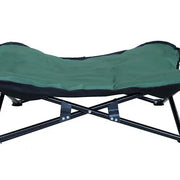Green dog camping cot with a durable black frame for elevated and breathable rest