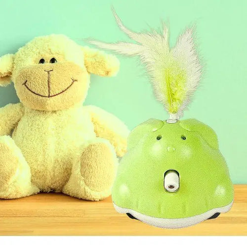 Green electronic toy with feather attachment next to a plush lamb