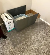 Large grey diamond-weave cat litter mat on carpet floor under litter box with foldable enclosure