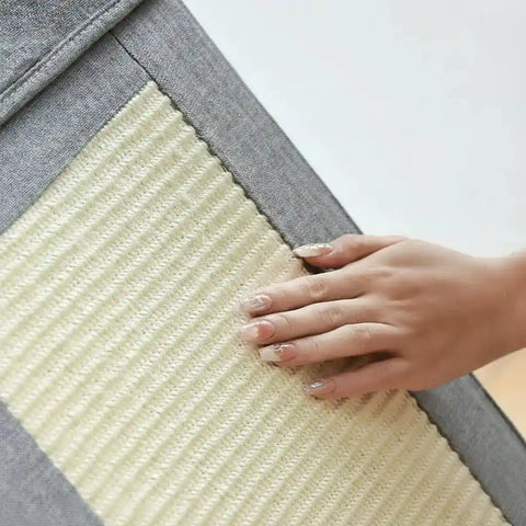 Hand touching a textured mat with text on dimensions and features.