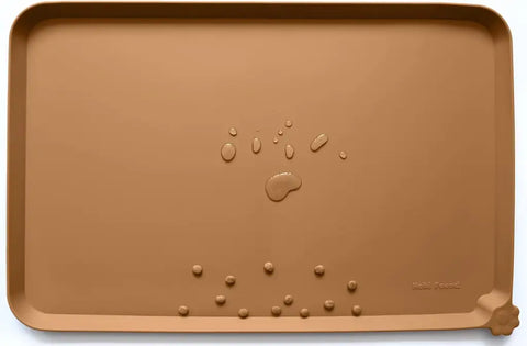 Butterscotch brown silicone pet food tray displaying water drops and dry kibble pieces.