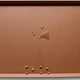 Caramel brown durable silicone pet feeding mat with raised borders and kibble.