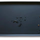 Hoki Found Dark Cedar charcoal black silicone dog bowl mat with water droplets and pet kibble.