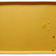 Honey warm golden brown silicone pet feeding mat with water droplets and kibble.