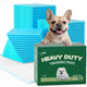 French Bulldog peeking over a green box of Immcute Heavy Duty Training Pads next to stacks of blue puppy pee pads.