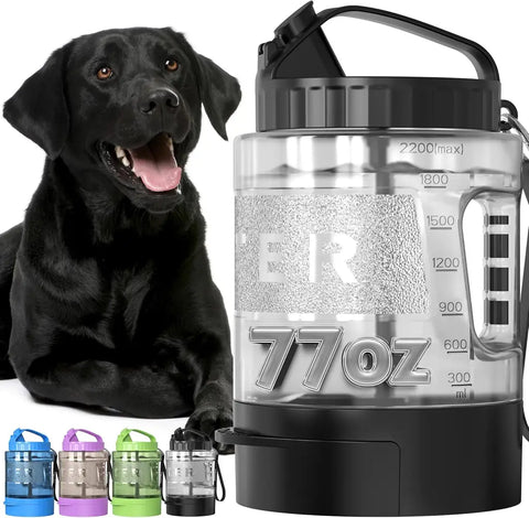 Large 77oz clear dog water bottle and travel jug with measurement lines next to a black dog