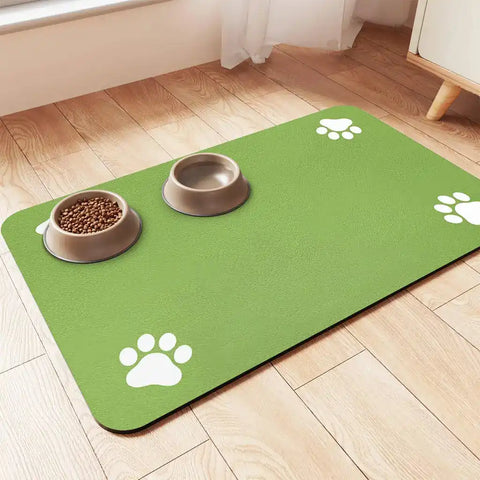 Vibrant lime green pet food mat with white paw print corners on a light wood floor.