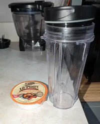 Customer lifestyle photo comparing a Merrick Lil Plates wet dog food cup next to a kitchen blender cup on a counter.