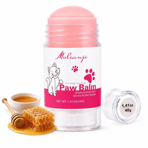 Molianji pink cat paw balm 40g stick container next to fresh honeycomb and a honey dipper.