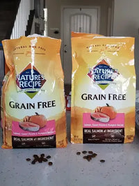 Customer image showing two 4 lb bags of Nature's Recipe Grain Free Salmon, Sweet Potato & Pumpkin Recipe standing on a kitchen countertop with loose kibble.