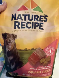 Real customer review image of a Nature's Recipe Grain Free Salmon, Sweet Potato & Pumpkin Recipe dog food bag being held.