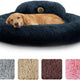 Golden retriever resting inside a large navy blue fluffy round donut pet bed