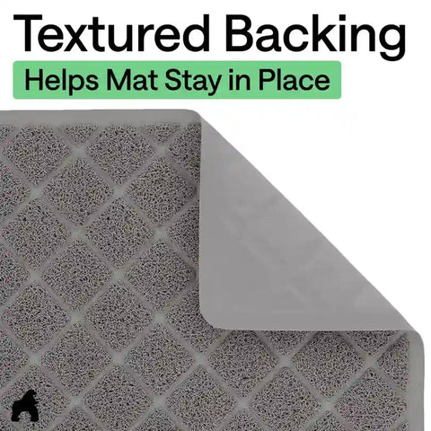 Close-up of grey cat litter mat showing its non-slip textured backing folded up at the corner