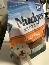 A bag of Nudges Natural Dog Treats Jerky Cuts featuring a white Maltipoo on the front packaging.