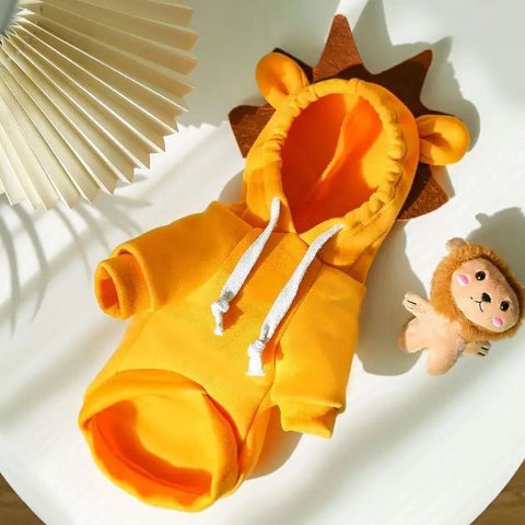Orange lion hoodie with a small lion plush toy on white surface.