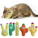 A kitten chewing on a green textured corduroy cat toy, shown alongside a 5-pack of colorful, funny-faced cactus catnip plush toys.