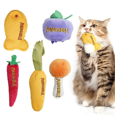 A fluffy domestic longhair cat biting a yellow fish plush toy, shown next to a 5-pack of Pawsible catnip toys including a blueberry, carrot, chili pepper, and drumstick.