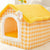 Pawvortex yellow and white checkered pet house with fluffy white flower accent on light background, featuring plush interior, washable design, and cozy double-roof structure for cats and small dogs in US homes.